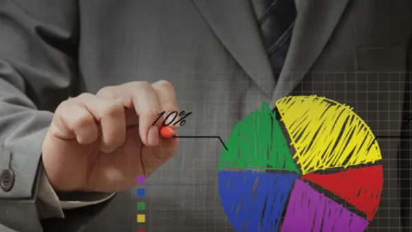 Person in business suit drawing a pie chart.